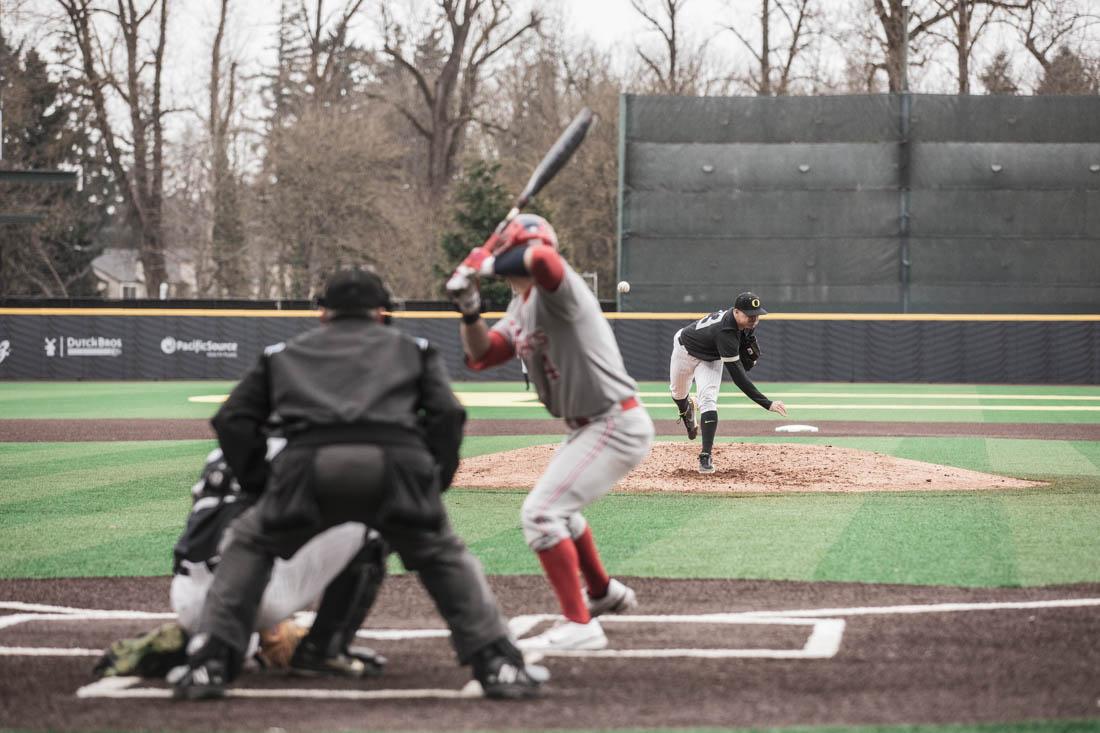 Ducks pitcher Andrew Mosiello (23) lets a pitch go towards Red Storm hitter. Ducks Baseball take on St. Johns Red Storm at PK Field in Eugene, Or., on Feb. 26, 2022. (Maddie Stellingwerf/Emerald)