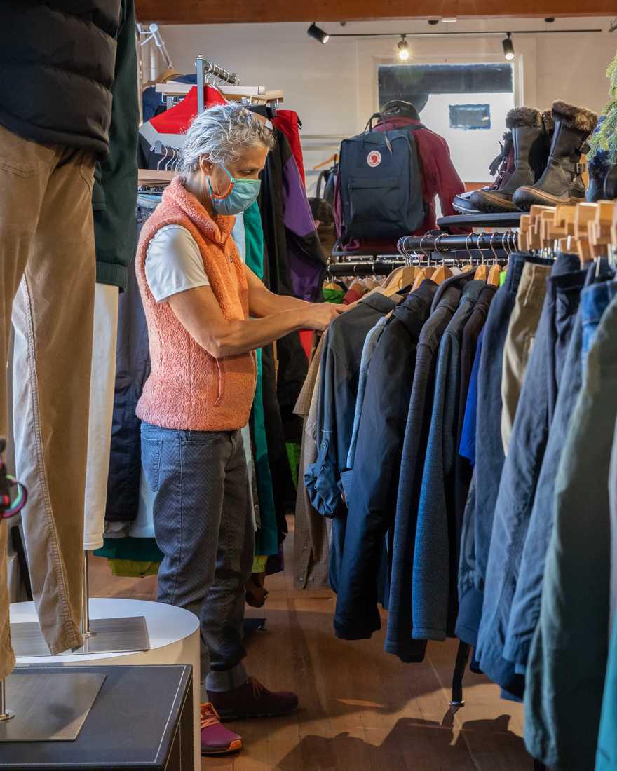 Sharon, one of the store&#8217;s employees, organizes the racks. The Eugene Gear Traders is a local consignment shop for outdoor gear. (Molly McPherson/Emerald)