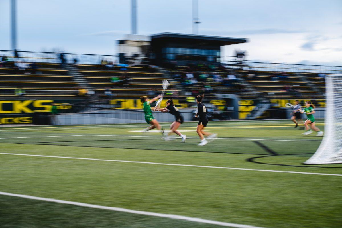 An Oregon player is hit by a tackle from a Boulder player. The University of Oregon Ducks lost to the University of Colorado Buffaloes 11-9 at PK Park on March 18, 2022. (Will Geschke/Emerald)