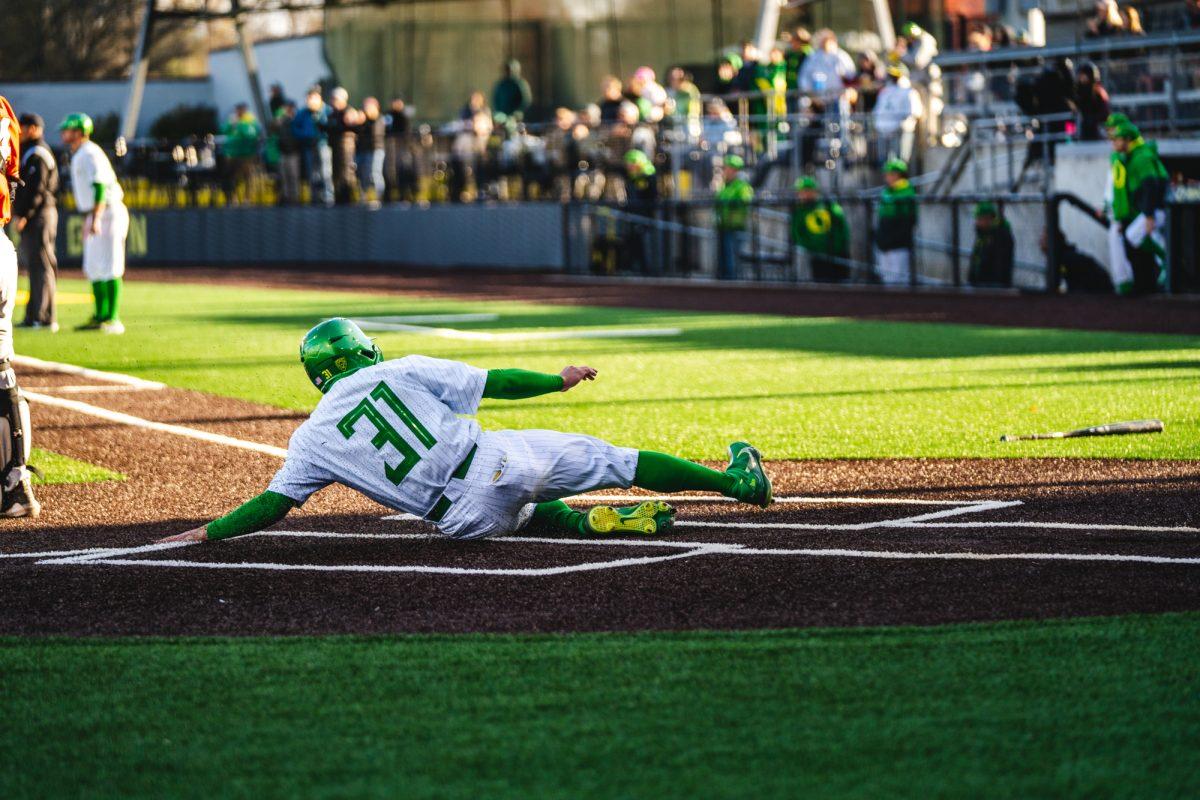 Tanner Smith (31) slides into home plate. The University of Oregon Ducks staged a late-game comeback to win 8-6 against the Utah Utes on March 19, 2022 at PK Park. (Will Geschke/Emerald)