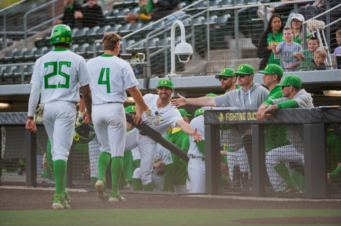 Josh Kasevich (4) and Jacob Walsh (25) head into the dugout after Oregon gets two runs. Oregon Baseball takes on the University of San Fransisco at PK Field in Eugene, Ore. on March 29, 2022. (Mary Grosswendt/Emerald)