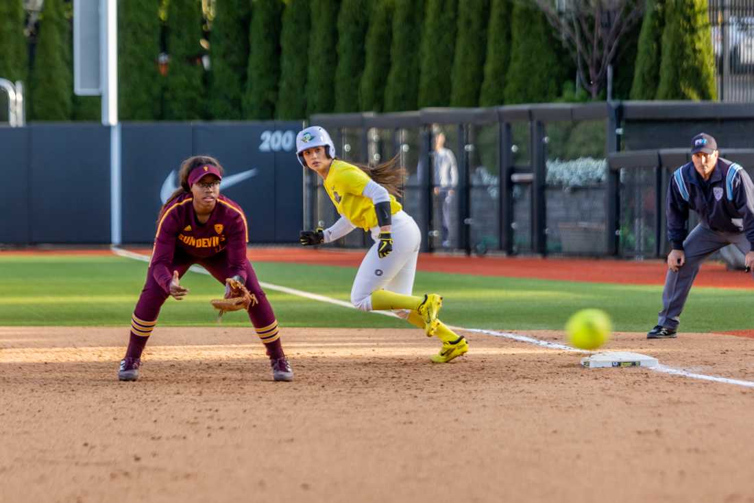 Ariel Carlson (03) begins to leave first as the pitch makes its way to the plate. Oregon Softball takes on Arizona State on April 8th, 2022, at Jane Sanders Stadium. (Molly McPherson/Emerald)