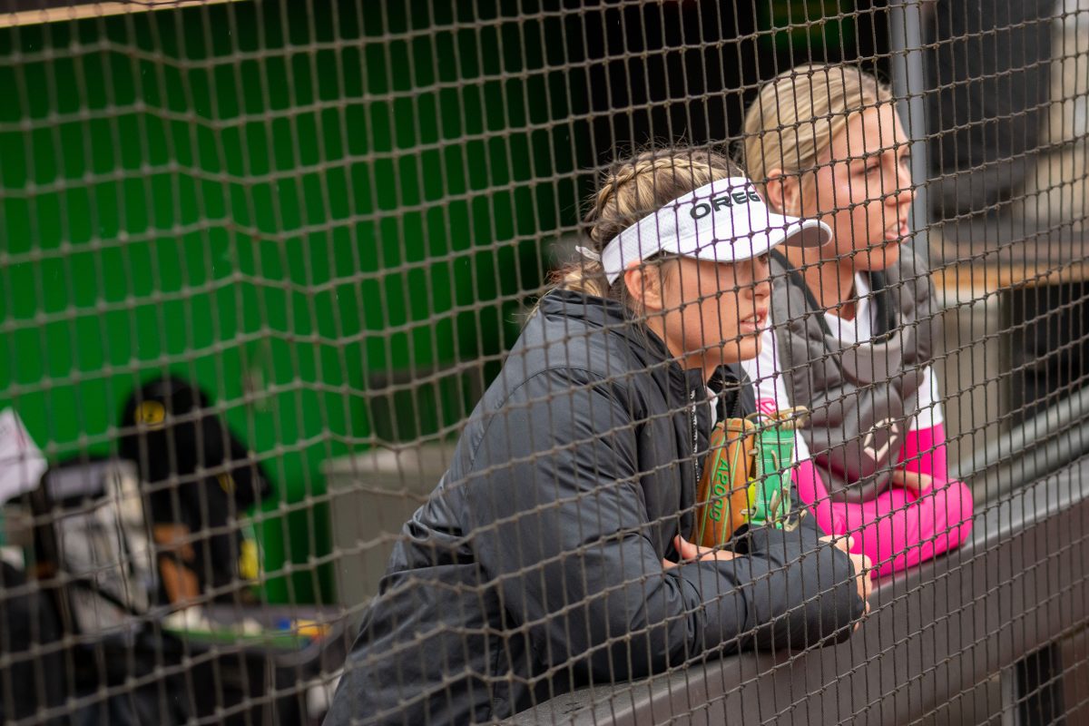 Stevie Hansen (00) and Terra McGowan (11) watch the opposing team warm up. The Oregon Ducks Softball Team takes on rival Oregon State on April 29th, 2022, at Jane Sanders Stadium. (Jonathan Suni, Emerald)&#160;