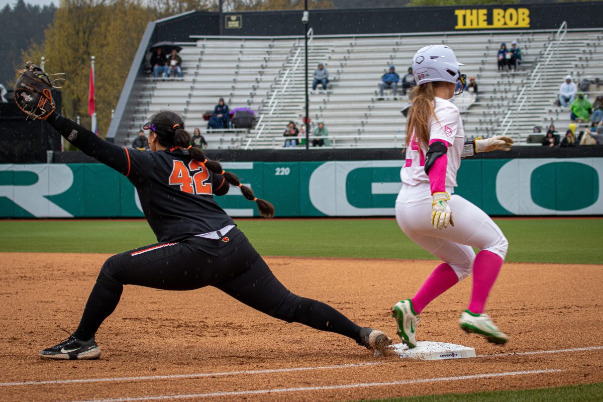 Hannah Delgado (24) makes it to first base safely despite the opposing players efforts.&#160;The Oregon Ducks Softball Team takes on rival Oregon State on April 29th, 2022, at Janes Sanders Stadium. (Jonathan Suni, Emerald)