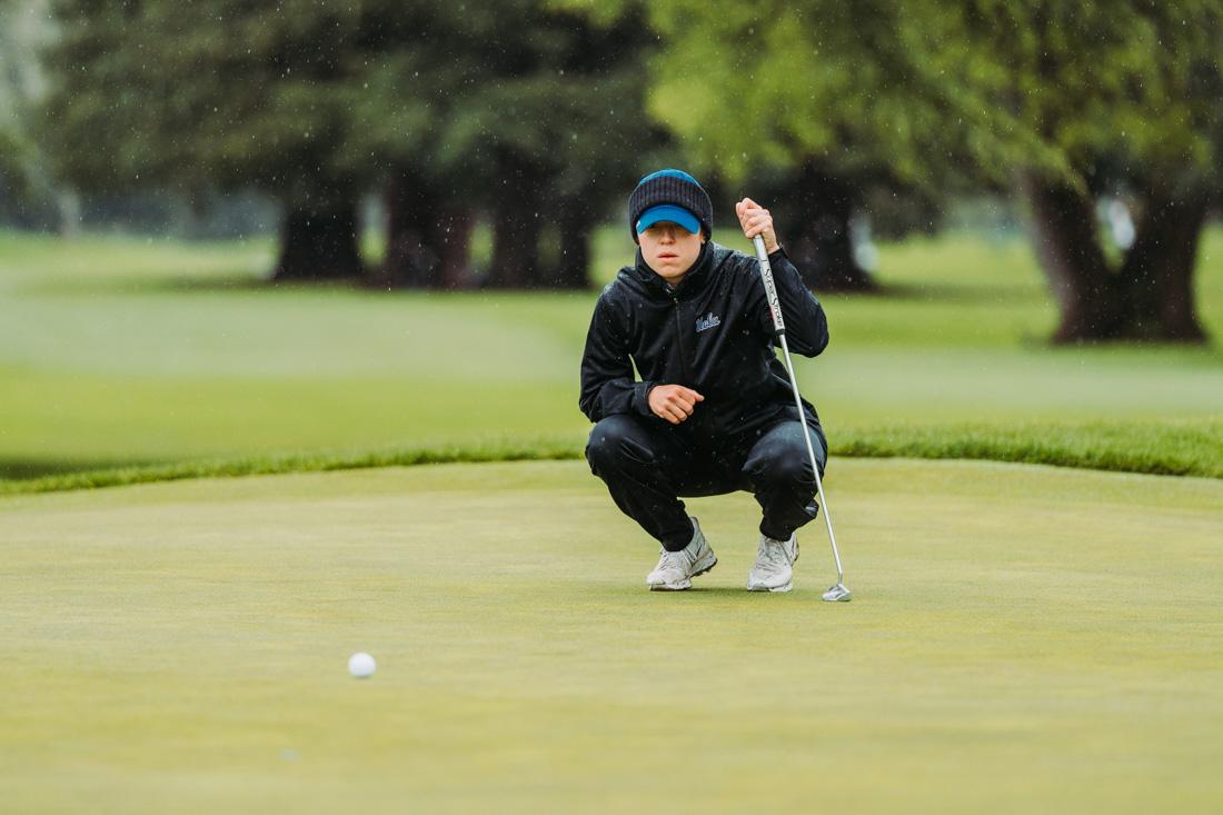 A UCLA golfer takes time to line up their putt on the green. The Eugene Country Club hosted the Pac-12 Women's golf championships from April 18-20, 2022. (Serei Hendrie/ Emerald)