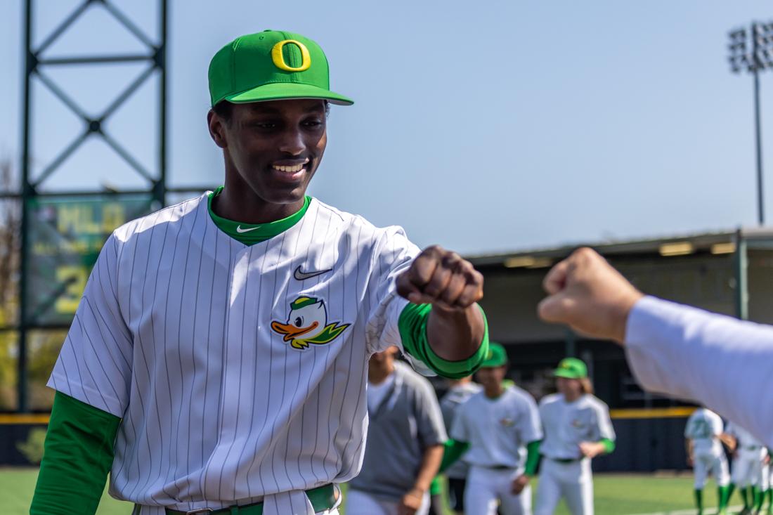 Freshman Cho Tofte (50) fist-bumps a coach prior to the game. The Oregon Ducks Baseball team takes on Washington State on April 23th, 2022, at PK Park. (Molly McPherson/Emerald)