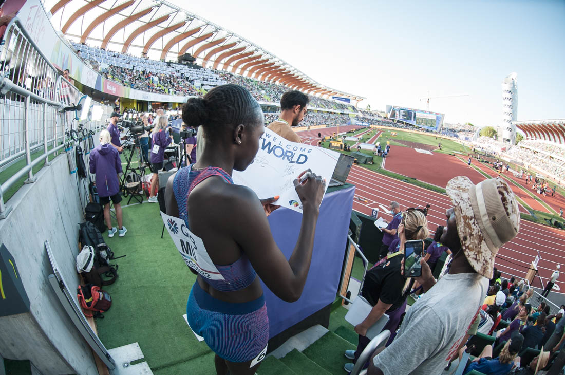 American distance runner Athing Mu gives an autograph to a fan between events. The World Athletics Championships continue onto day eight at Hayward Field in Eugene, Ore., on July 22, 2022. (Maddie Stellingwerf/Emerald)