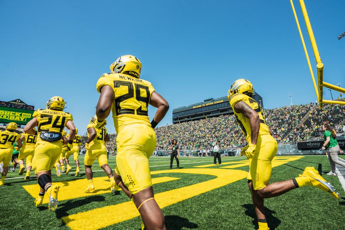 Yellow Team explodes out of their side of the field to the sounds of cheering fans. The Oregon Football team competes in it's annual spring game on April 23rd, 2022 at Autzen Stadium in Eugene, Ore. (Serei Hendrie/Emerald)