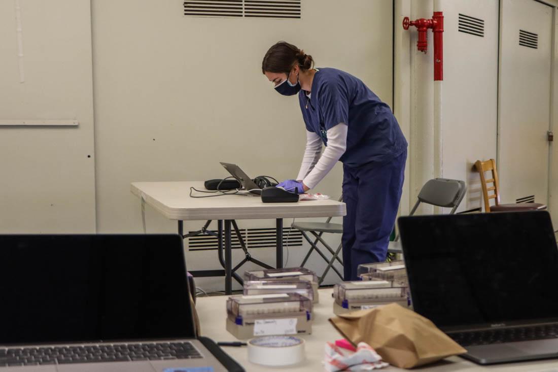 <p>Nurses work hard to conduct, process and get test results back to Lane County residents within 2-4 days. After previously only testing asymptomatic individuals, the UO Monitoring and Assessment Program testing site now allows those with mild, cold-like symptoms to also get tested for COVID-19. (Mary Grosswendt/Emerald)</p>