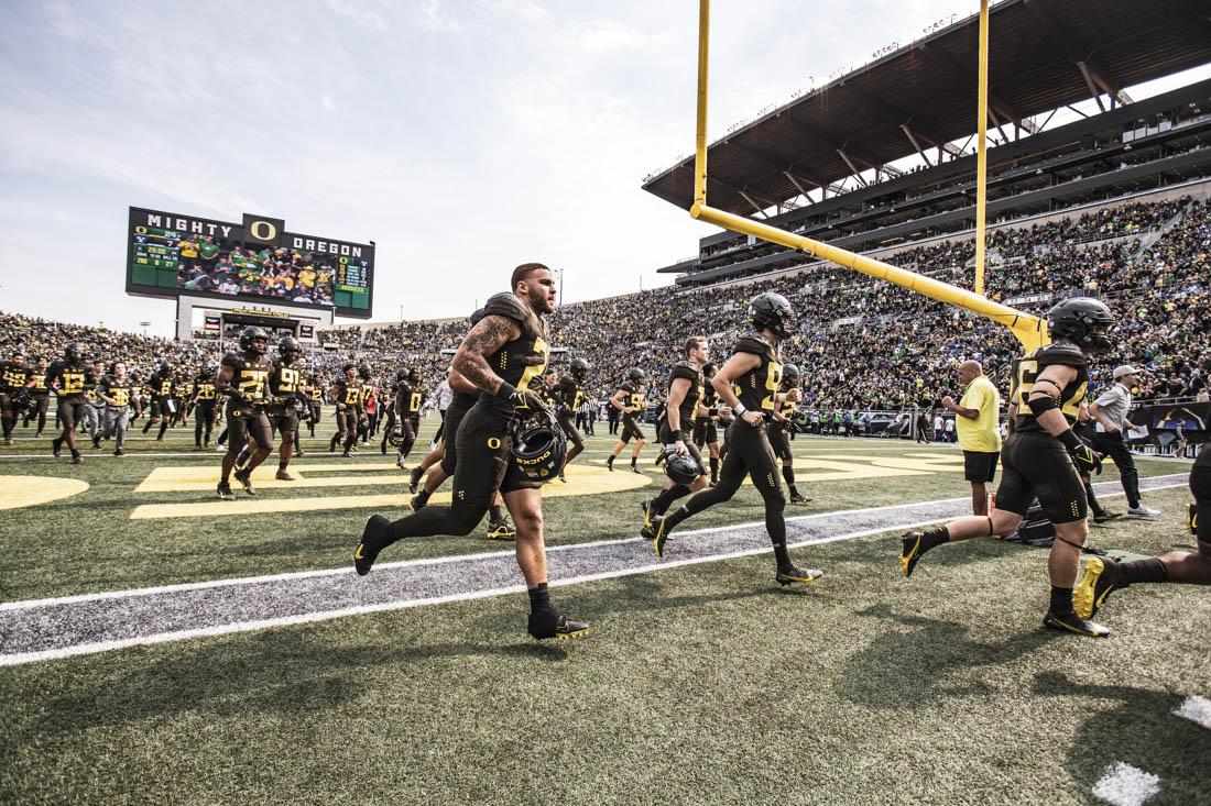 Ducks players run back to their respective locker rooms as half time begins. University of Oregon Ducks Football defeat the BYU Cougars in a home match at Autzen Stadium in Eugene, Ore., on Sep. 17, 2022. (Maddie Stellingwerf/Emerald)