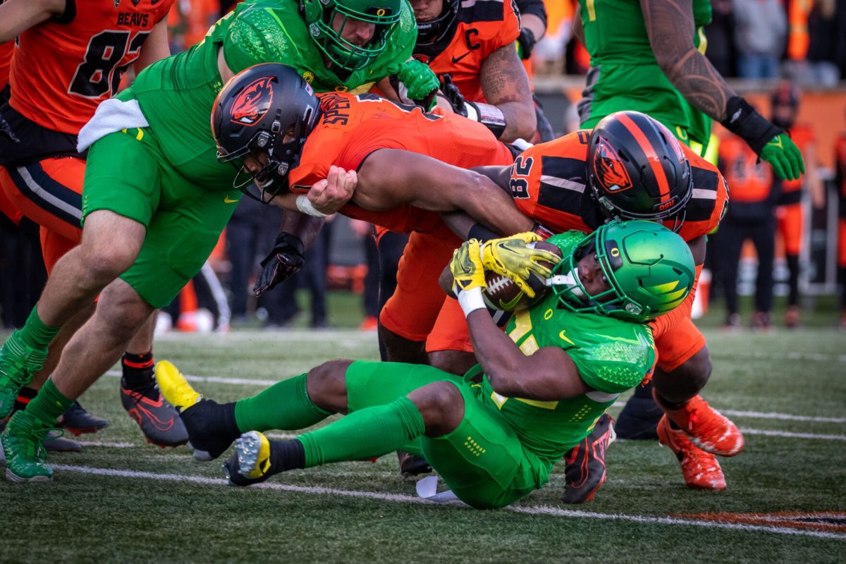 Noah Whittington (22) protects the ball as he falls backwards into an Oregon State defender.&#160;The Oregon Ducks travel up to Corvallis to face their in-state rival the Oregon State Beavers on November 26th, 2022, for their last game of the regular season.&#160;(Jonathan Suni, Emerald)