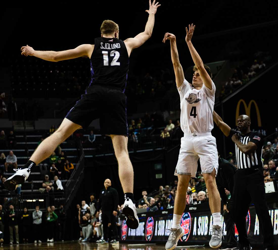 Ducks guard Brennan Rigsby (4) jumps into the air and shoots the ball. The University of Oregon Ducks defeat the University of Portland Pilots 78-56 at Matthew Knight Arena in Eugene, Ore., on December 17th, 2022. (Ian Enger/Emerald)