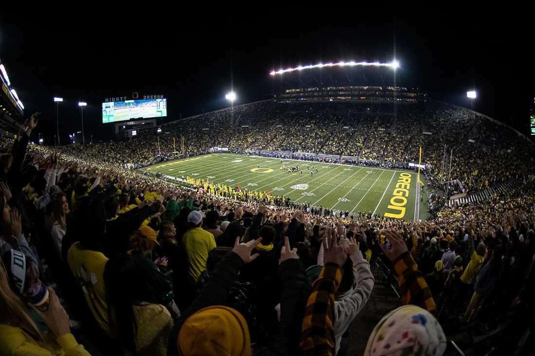 Duck fans raise their hands in support during tonight's game against the University of Washington Huskies. The University of Oregon Ducks hosted the University of Washington Huskies at Autzen Stadium in Eugene, Ore., on November 12th, 2022 for game 10 of the 2022 season. (Ian Enger/Emerald)