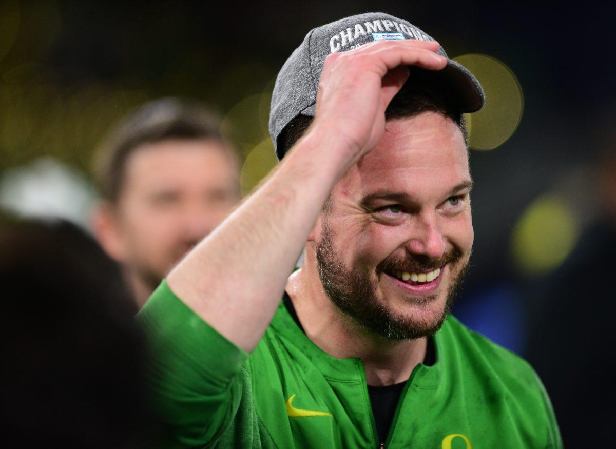 Oregon head coach Dan Lanning puts on a Holiday Bowl champions hat on Wednesday, Dec. 28, 2022 at Petco Park in San Diego. Lanning celebrated Oregon's victory over North Carolina on the field with players and family.&#160;