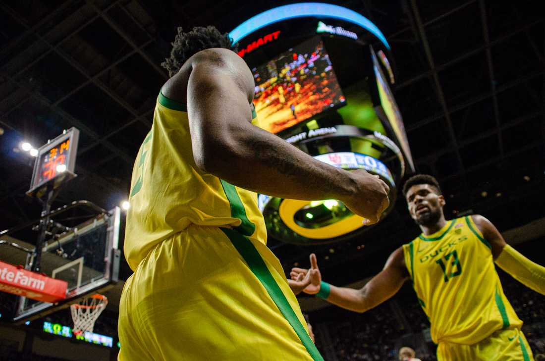 Oregon guard Jermaine Couisnard (5) and forward Quincy Guerrier (13) high five each other before a timeout. The University of Oregon Ducks defeat the University of Utah Utes 68-56 at Matthew Knight Arena in Eugene, Ore., on January 28th, 2023.(Kai Kanzer/Emerald)