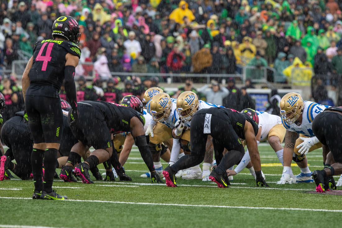 It starts to rain in Autzen as the Ducks line up for a defensive drive. Oregon Ducks take on the UCLA Bruins at Autzen Stadium in Eugene, Ore., on Oct. 22, 2022. (Ali Watson/Emerald)