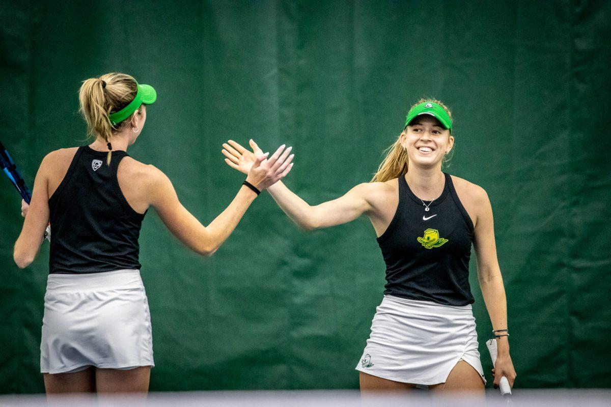 Myah Ptechey smiles and high fives her teammate after earning a great point.&#160;The Oregon Women's Tennis team hosts Portland State at the Student Tennis Center in Eugene, Ore., on January 20th. (Jonathan Suni, Emerald)