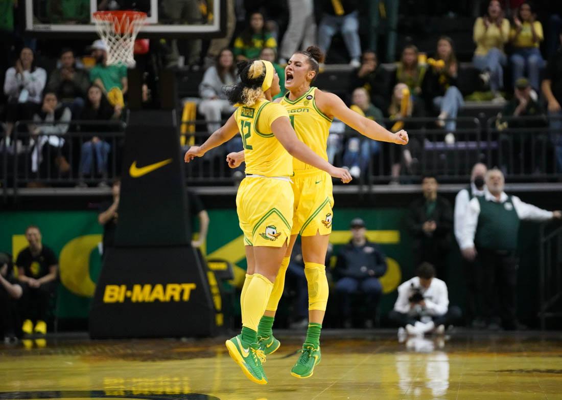 Ducks guards Te-Hina Paopao and Taya Hanson celebrate a crucial fourth quarter basket. Oregon women's basketball defeat Washington 65-58 at Matthew Knight Arena on Jan. 13. (Jackson Knox/Emerald)