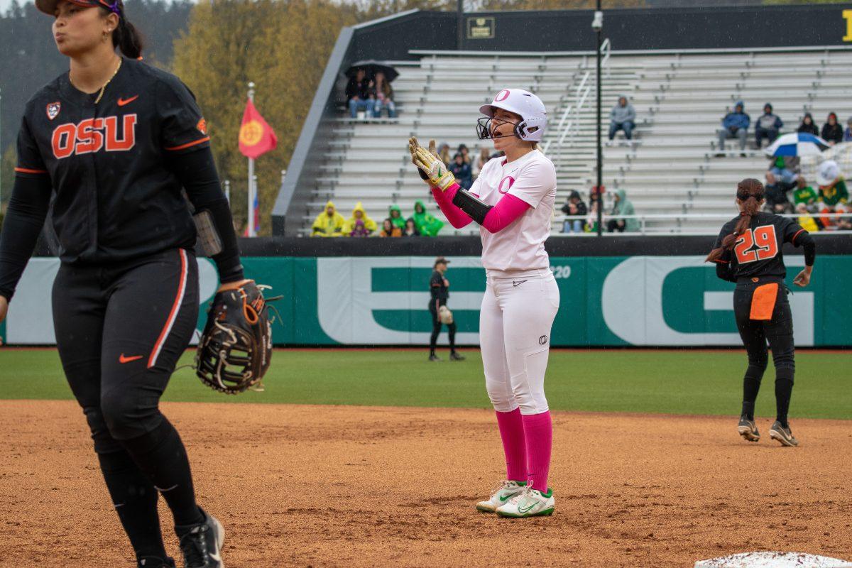 Terra McGowan (11) cheers on a fellow Duck from first base.&#160;The Oregon Ducks Softball Team takes on rival Oregon State on April 29th, 2022, at Janes Sanders Stadium. (Jonathan Suni, Emerald)