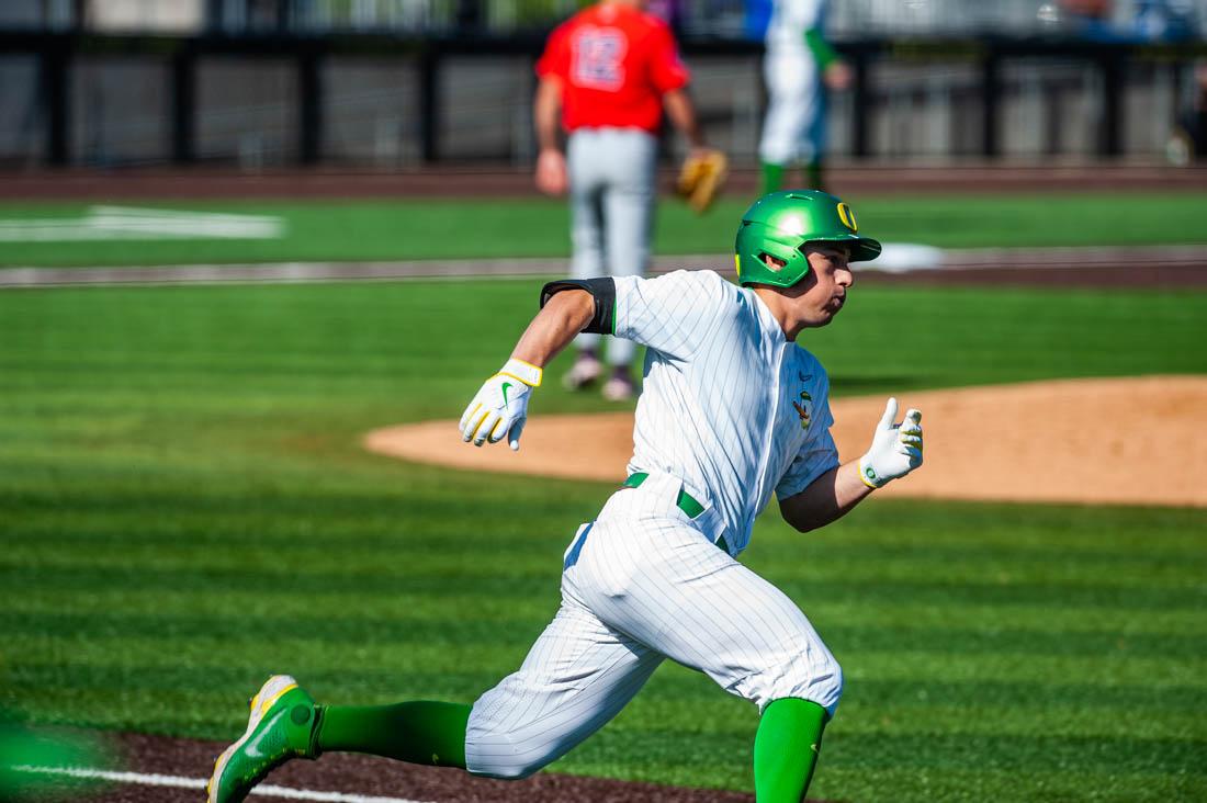 Drew Cowley (15) rounds first base after a hit into the outfield. Oregon Baseball takes on University of Arizona at PK Field in Eugene, Ore. on May 20, 2022. (Mary Grosswendt/Emerald)