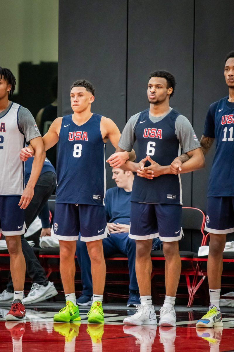 Possible future college teammates, Bronny James (6) and Jackson Shelstad (8) link arms as they listen to their coach. (Jonathan Suni, Emerald)