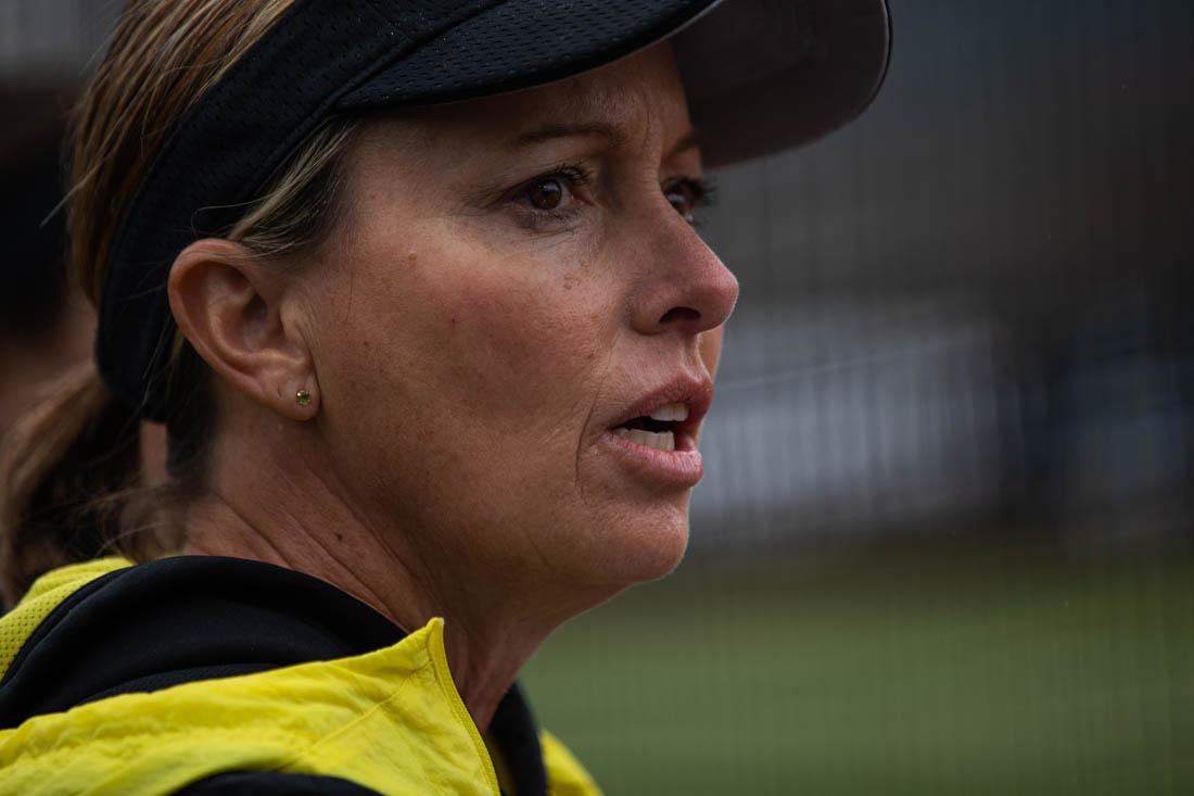 Ducks head coach Melyssa Lombardi gives play signs to Ducks pitcher. University of Oregon Ducks softball take on the Stanford Cardinal at Jane Sanders Stadium in Eugene, Ore., on Mar. 19, 2023. (Maddie Stellingwerf/Emerald)