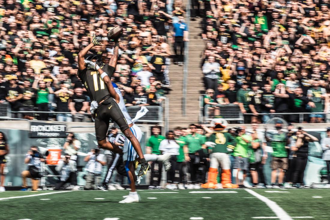 Ducks sophomore wide receiver Troy Franklin (11) leaps to catch a ball with Cougar defense right behind. University of Oregon Ducks Football defeat the BYU Cougars in a home match at Autzen Stadium in Eugene, Ore., on Sep. 17, 2022. (Maddie Stellingwerf/Emerald)