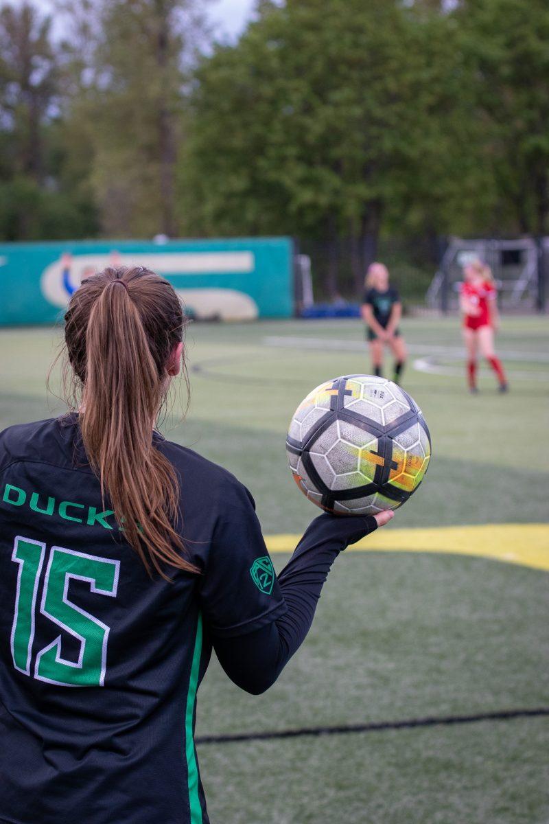 Megan Rucker (15) holds the ball as she surveys the field in preparation to throw the ball into play.&#160;The Oregon Ducks Soccer Team Host Western Oregon at Pape Field on May 7, 2022. (Jonathan Suni, Emerald)