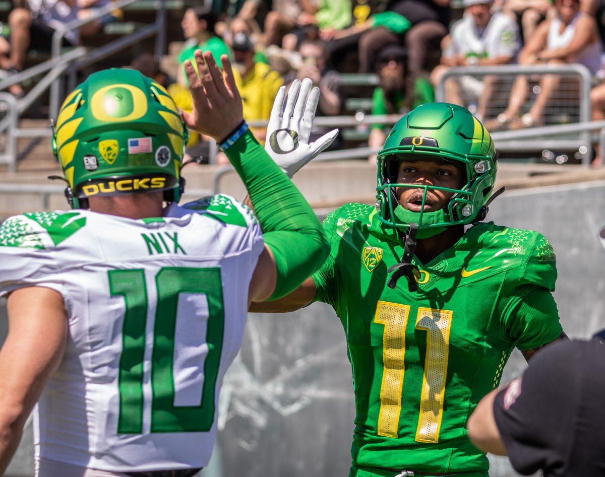 Bo Nix (10) and Troy Franklin (11) high-five after gaining the lead on the yellow team.&#160;The University of Oregon holds their annual spring game&#160;at Autzen Stadium in Eugene, Ore., on April 29, 2023. (Jonathan Suni, Emerald)