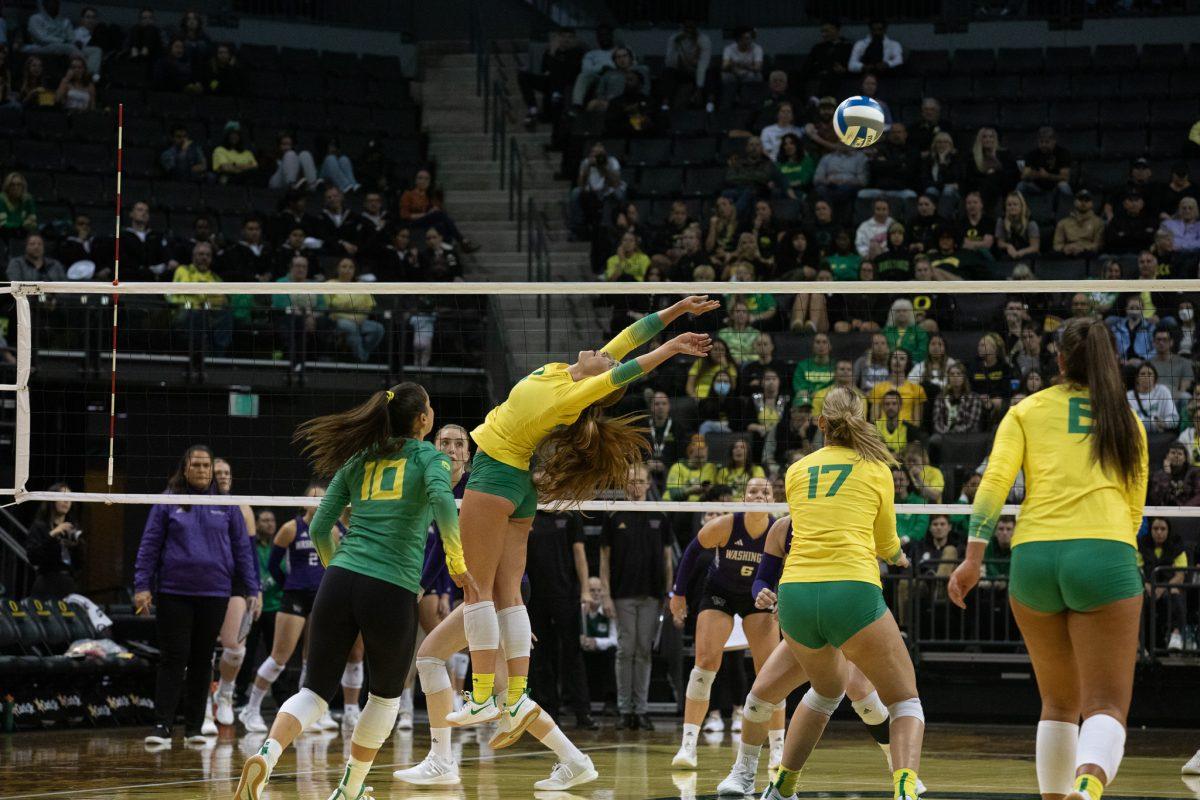 Oregon Duck stretches her body to giver her fellow Duck an opportunity to hit the ball back to the opposing team.&#160;The University of Oregon Ducks volleyball team defeated the University of Washington in a home match at Matthew Knight Arena in Eugene, Ore., on Sept. 29, 2023. (Sebastian Flores/Emerald)