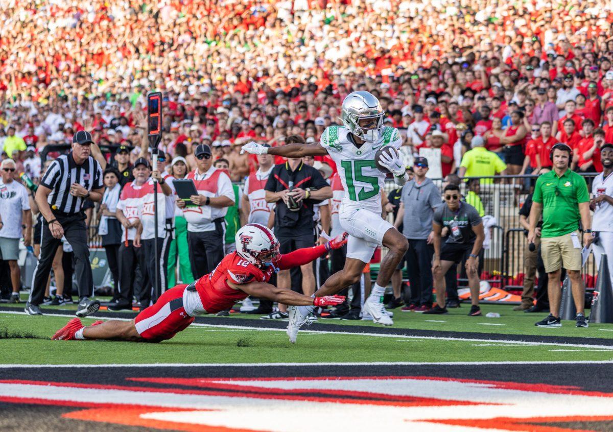 Newly transferred Oregon receiver Tez Johnson (15) breaks a tackle to double the Oregon Ducks' lead.&#160;The Oregon Ducks battle in a close fight to ultimately beat the Texas Tech Red Raiders in their home opener at Jones AT&amp;T Stadium in Lubbock, Texas, on Sept. 9, 2023. (Jonathan Suni/Emerald)