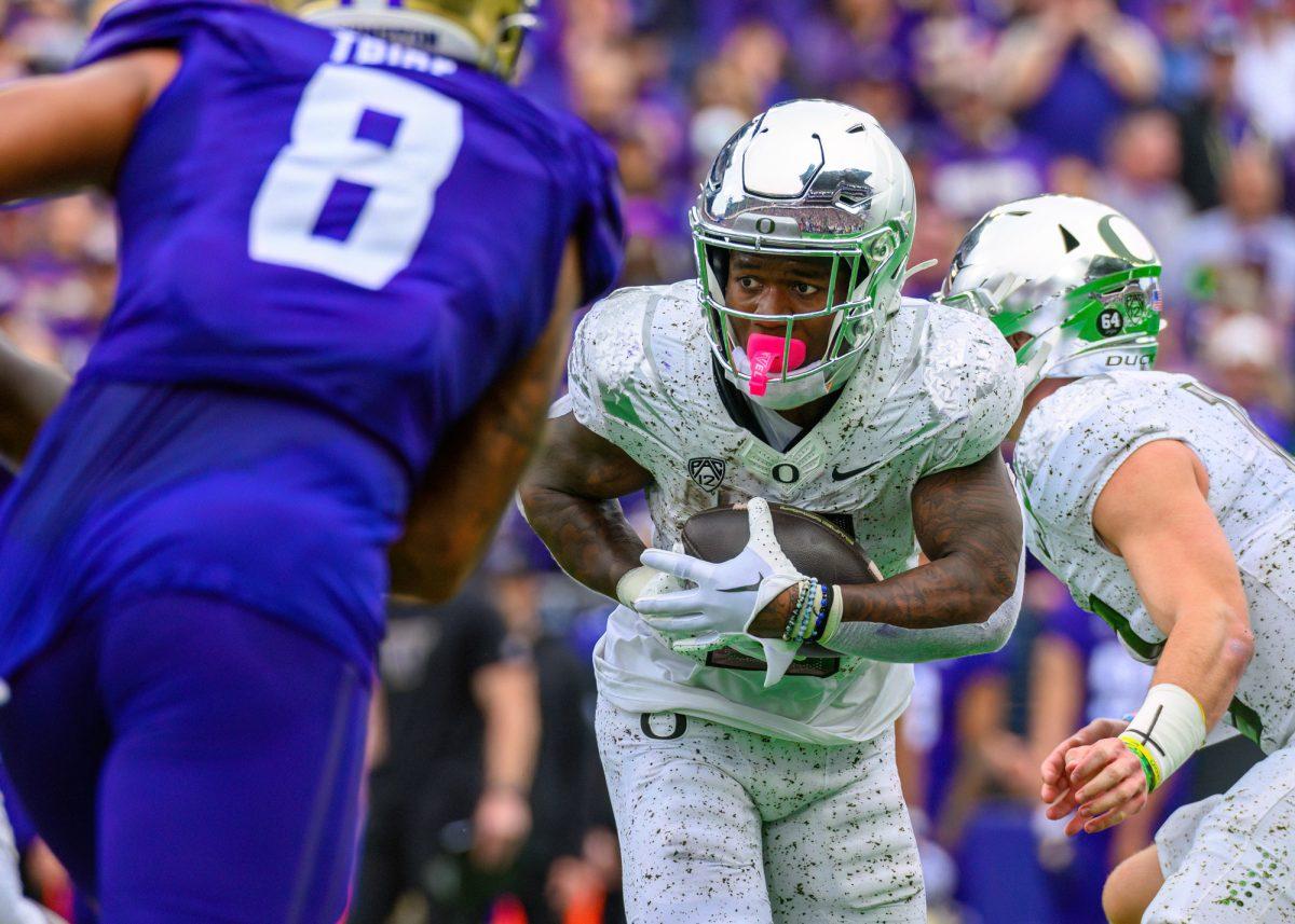 Bucky Irving (0) runs the ball. The University of Oregon Ducks Football team were defeated by the University of Washington Huskies in an away match at Husky Stadium in Seattle, Washington, on October 14, 2023. (Eric Becker/Emerald)