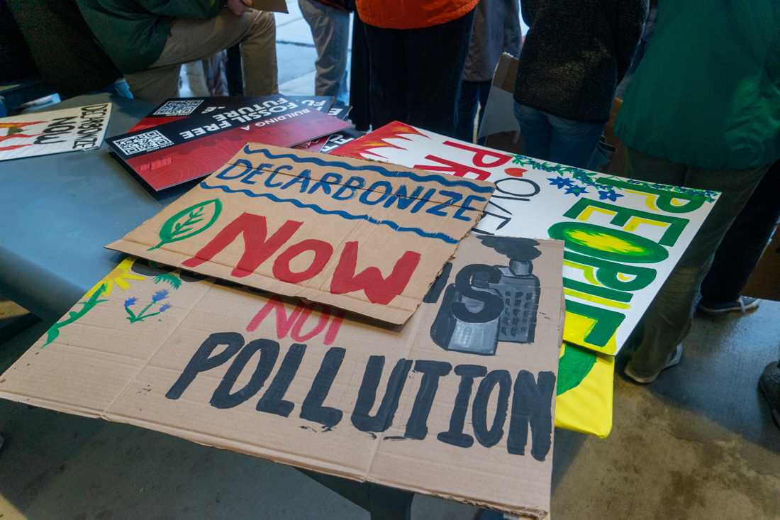 Students and community members gathered in the rain on Oct. 24, 2023 to protest with the purpose of urging the University of Oregon to transition to a clean energy source. (Lulu Devoulin/ Emerald)