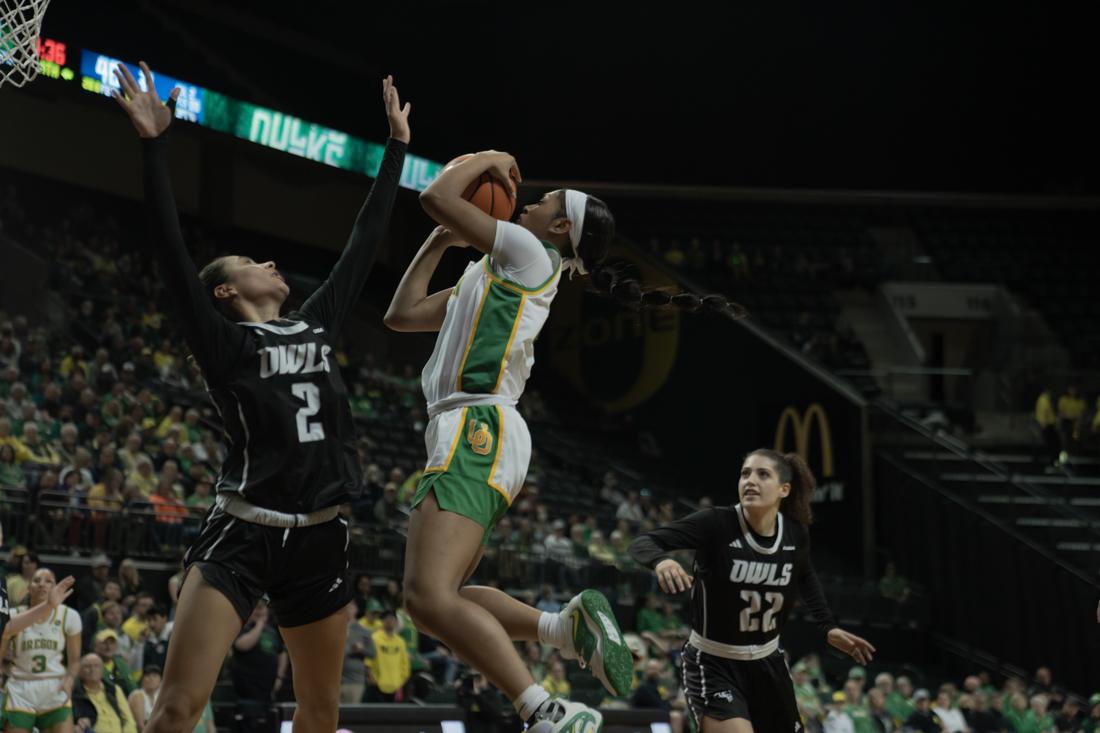 Chance Gray (#2) elevates over Dominique Ennis for a bucket. University of Oregon Women's Basketball hosts Rice University in the WNIT Second Round. (Skyler Davis/ Emerald)