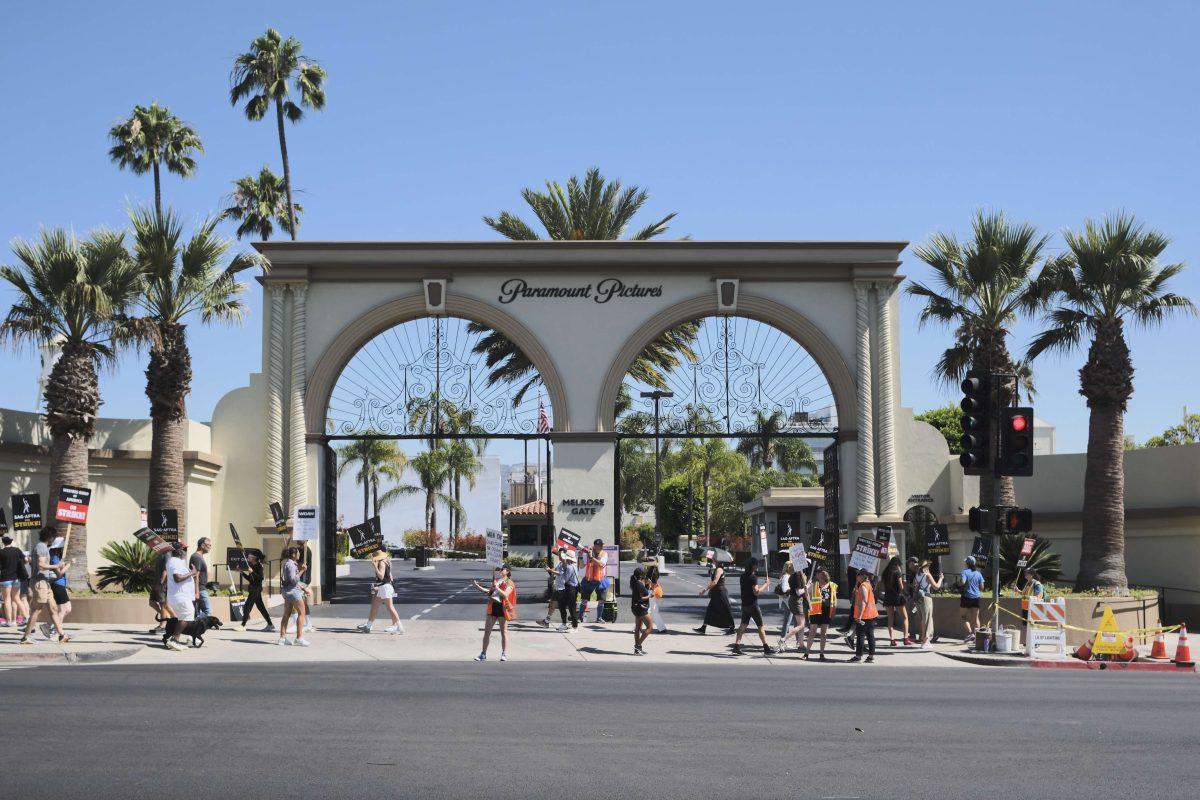 Outside Paramount Studios in Hollywood, writers and actors walk, chant and cheer as they picket one of the many large studios scattered around LA.