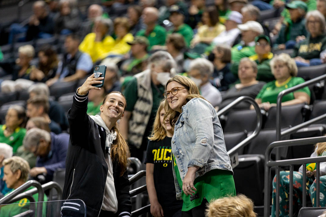 Sabrina Ionescu takes pictures after the game with Oregon fans. The University of Oregon Women&#8217;s basketball team beat the Southern Oregon Raiders 76-55 at Matthew Knight Arena in Eugene, Ore., on Oct. 29, 2023. (Kemper Flood/ Emerald)