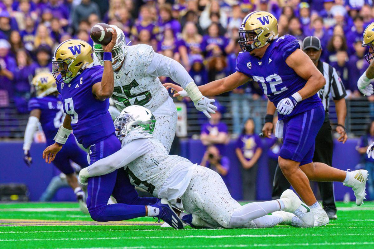 Michael Penix Jr. (9) is sacked by the Oregon defense. The University of Oregon Ducks Football team were defeated by the University of Washington Huskies in an away match at Husky Stadium in Seattle, Washington, on October 14, 2023. (Eric Becker/Emerald)