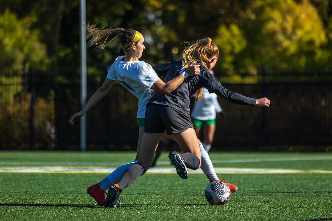 Oregon forward Ryann Reynolds (11) fights for possession of the ball against Washington State's Reese Tappan(2). The Oregon Ducks women&#8217;s soccer team takes on the Washington State Cougars on Oct. 29, 2023, in Eugene, Ore. (Molly McPherson/Emerald)