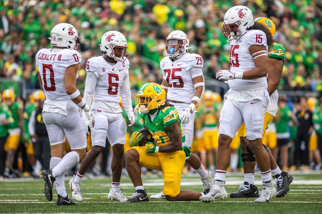 Jordan James (20) celebrates in a sea of Cougars. The Oregon Ducks football team takes on the Washington State Cougars on Oct. 21, 2023, in Eugene, Ore. (Molly McPherson/Emerald)