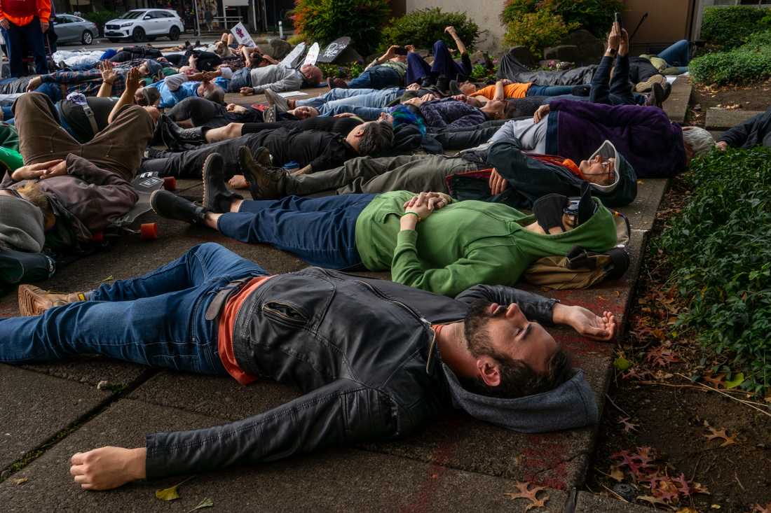 On Friday, Oct. 13, 2023, protestors gathered in opposition of the looming closure of PeaceHealth&#8217;s University District location. The group participated in a 20 minute &#8220;die-in&#8221; while community members spoke about the potential impact this closure would have on Eugene. (Lulu Devoulin/Emerald)