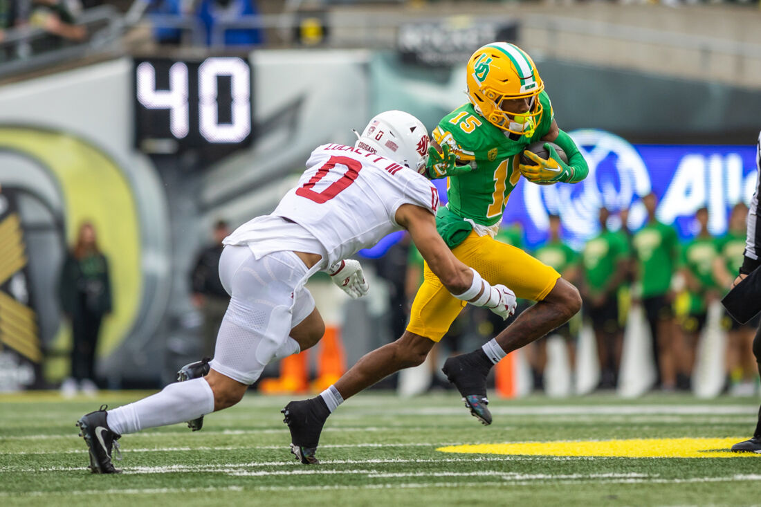 Washington State defensive back Sam Lockett III (0) dives to tackle Oregon's Tez Johnson (15). The Oregon Ducks football team takes on the Washington State Cougars on Oct. 21, 2023, in Eugene, Ore. (Molly McPherson/Emerald)