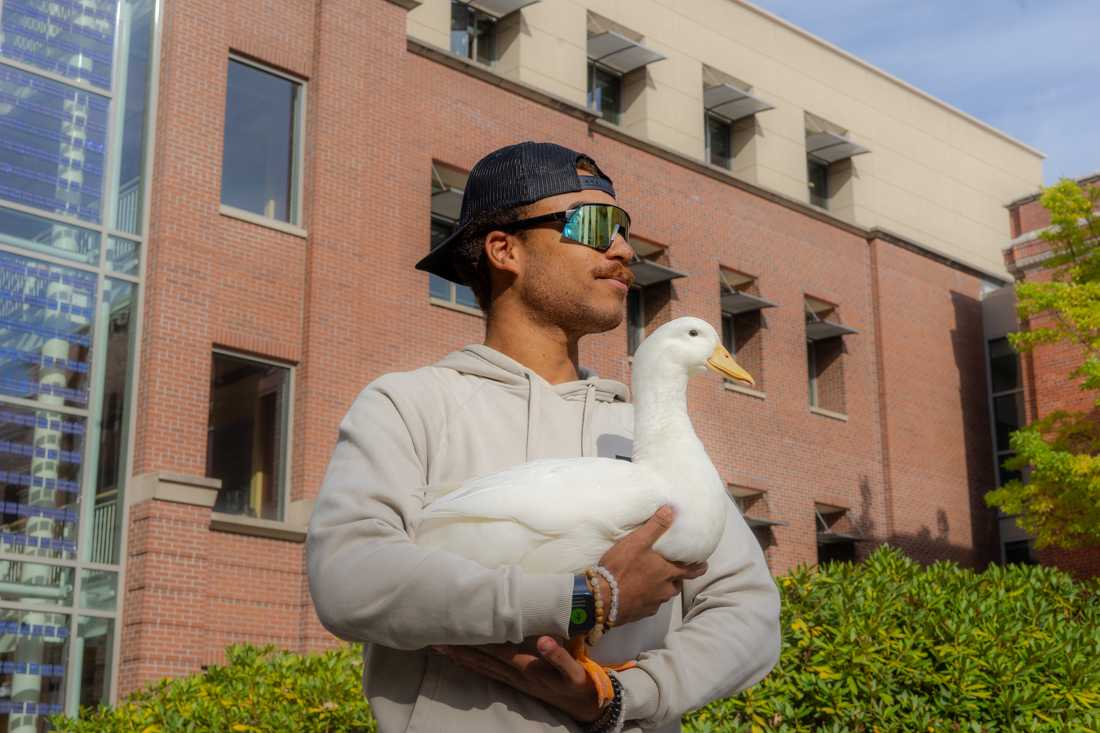 Jeremy and his infamous pet duck, Quacktavious. The duo gained popularity on campus after Jeremy brought Quacktavious to an Oregon football game at Autzen Stadium. (Lulu Devoulin/ Emerald)