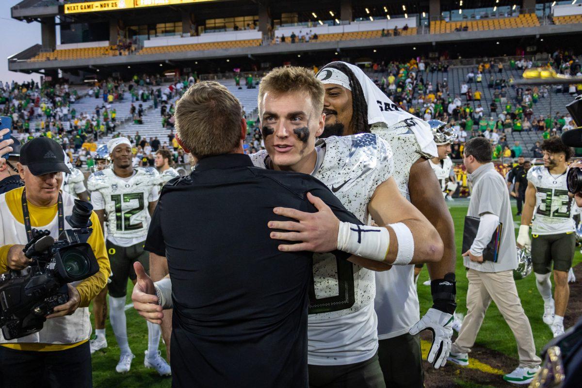 In 2019, Kenny Dillingham was the offensive coordinator and quarterback coach for Bo Nix at Auburn. In 2021, Kenny Dillingham and the Ducks convinced Bo Nix to leave Auburn and transfer to Oregon where they would lead a dominant Oregon offense in 2022. Now, in 2023, the two meet at center field after the Ducks crush a Dillingham led Sun Devil team. The Oregon Ducks crush the Arizona State Sun Devils at Mountain America Stadium in Tempe, Ariz., on Nov. 18, 2023. (Jonathan Suni/Emerald)