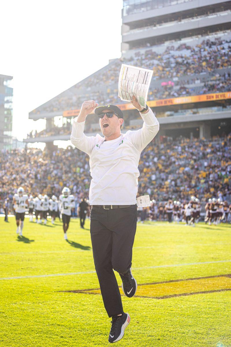 Ducks offensive coordinator, Will Stein, pumps up the large crowd of Oregon fans as the team heads back to the locker rooms for half time. Both sides of the ball for Oregon had a lot to be happy with the 42-0 lead at the half. The Oregon Ducks crush the Arizona State Sun Devils at Mountain America Stadium in Tempe, Ariz., on Nov. 18, 2023. (Jonathan Suni/Emerald)