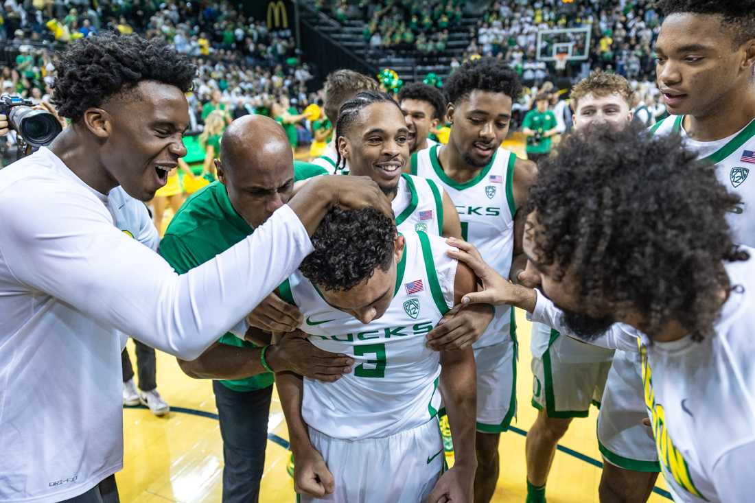 The Ducks celebrate with Jackson Shelstad (3) after he makes the game-winning shot. The Oregon Ducks men&#8217;s basketball team takes on the Michigan Wolverines on Dec. 2, 2023 in Eugene, Ore. (Molly McPherson/Emerald)