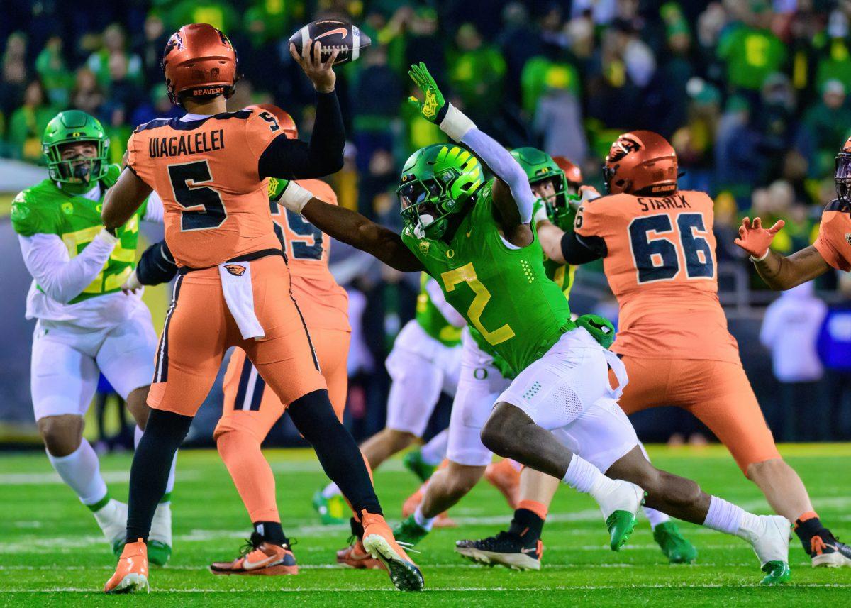 Oregon LB Jeffery Bassa (2) puts pressure on OSU QB DJ Uiagalelei (5). The University of Oregon Ducks Football team defeated Oregon State University 31-7 in a home match at Autzen Stadium in Eugene, Ore., on Nov. 24, 2023. (Eric Becker/Emerald)