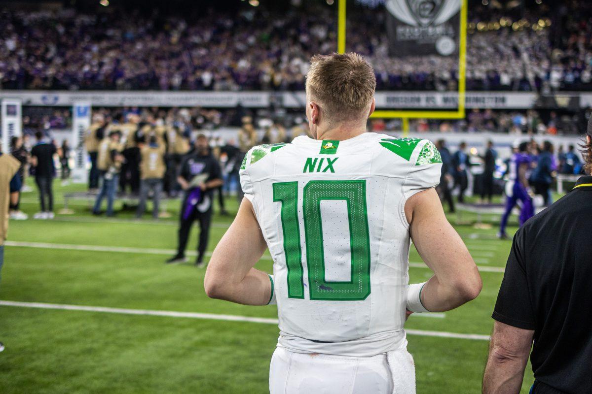 Oregon quarterback, Bo Nix (10), watches the Huskies celebrate their PAC-12 title and entrance to the college football playoff as he heads to the locker room. Nix will finish his college career without winning a national championship.&#160;The Washington Huskies defeat the Oregon Ducks football team in the Pac-12 Championship at Allegiant Stadium in Las Vegas on Dec. 1, 2023. (Jonathan Suni/Emerald)