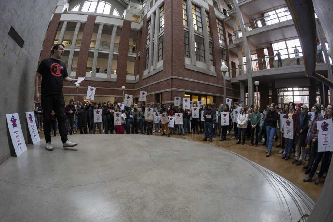 Graduate Teaching Fellows Federation representatives lead chants at the demonstration. Around 100 graduate researcher employees participated in a walkout demonstration on Nov. 29, 2023 in Willamette Hall. (Alex Hernandez/Emerald)