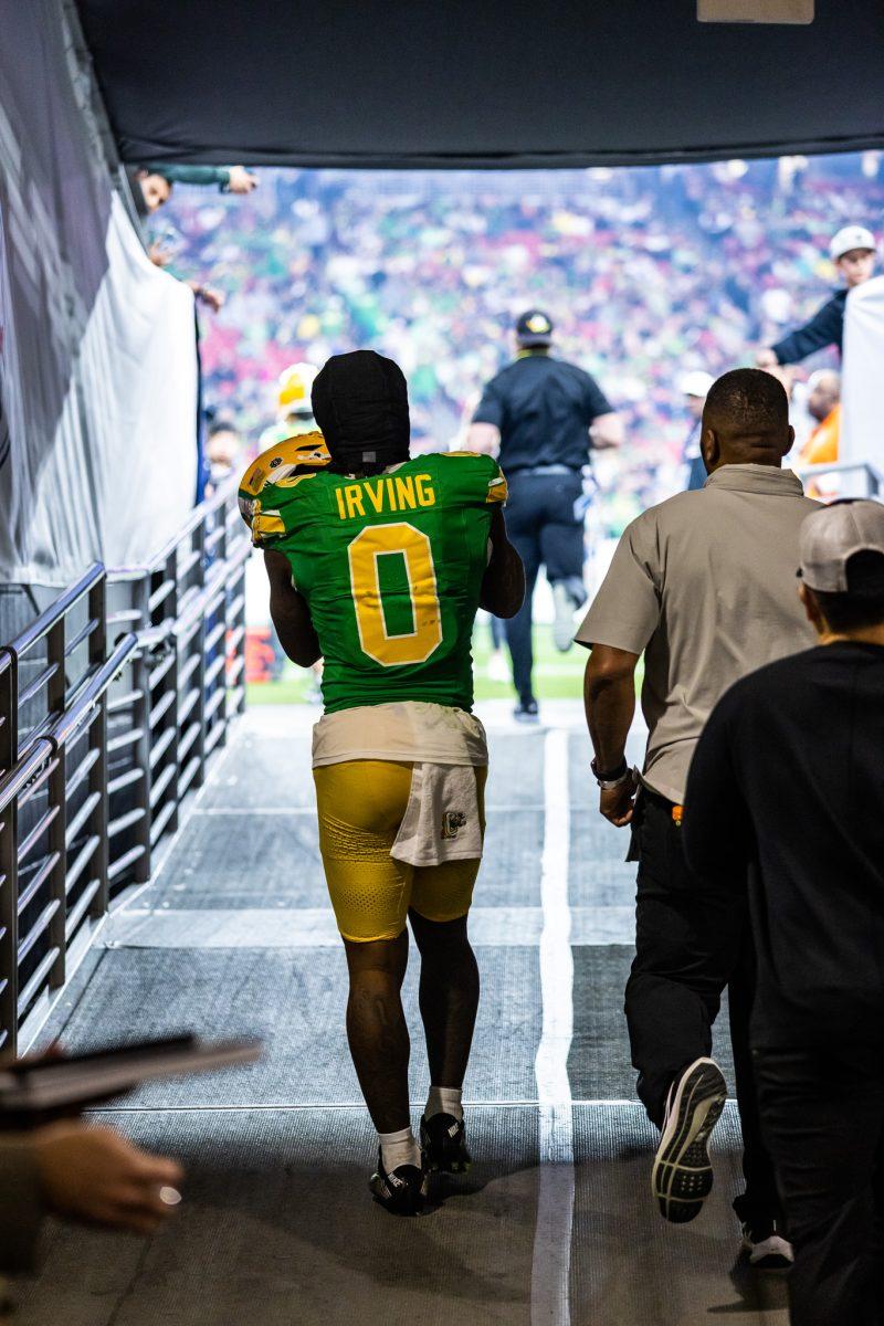 Bucky Irving (0) walks onto the field for the second half of his final collegiate game with the Oregon Ducks as he plans to pursue his life long dream of being drafted to the NFL.&#160;The Oregon Ducks crush the Liberty Flames at State Farm Stadium in Glendale, Ariz., on Jan. 1, 2024. (Jonathan Suni/Emerald)