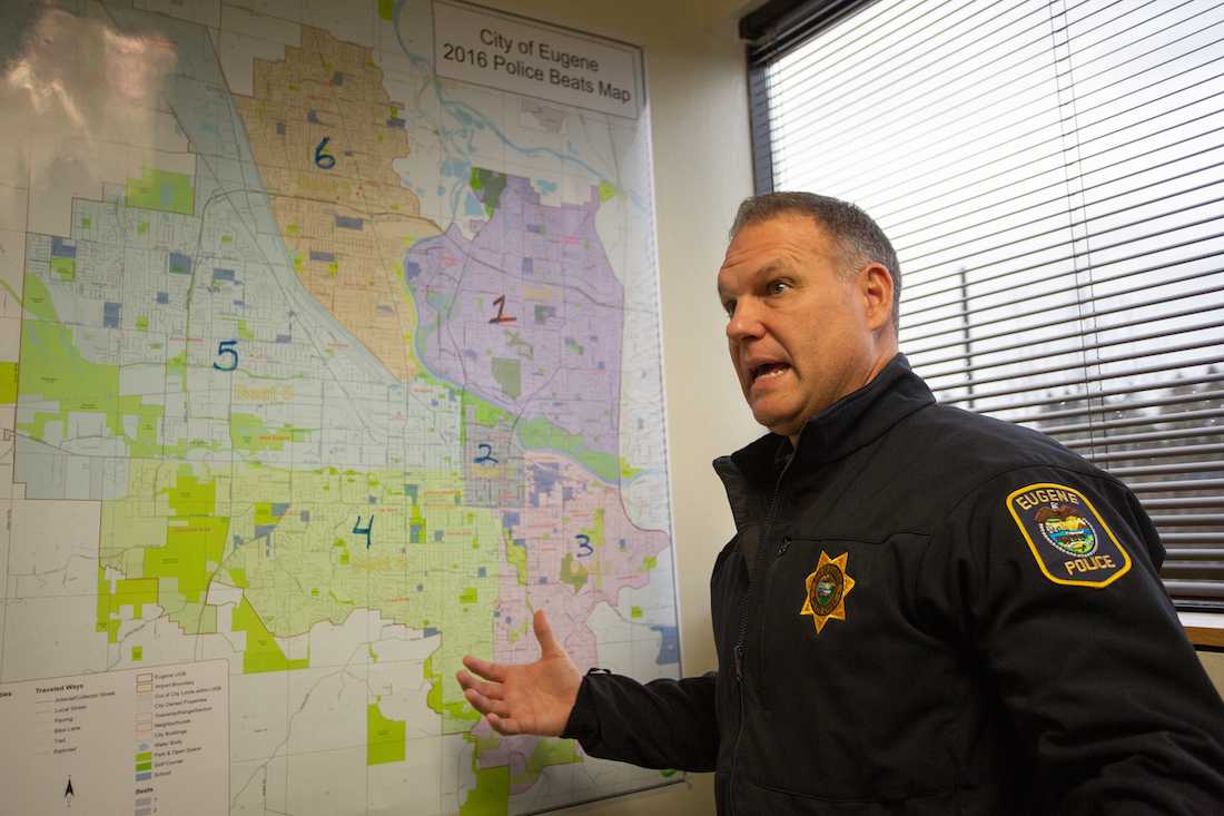 EPD Chief Chris Skinner examines a map of Eugene's different districts. (Sarah Northrop/Emerald)